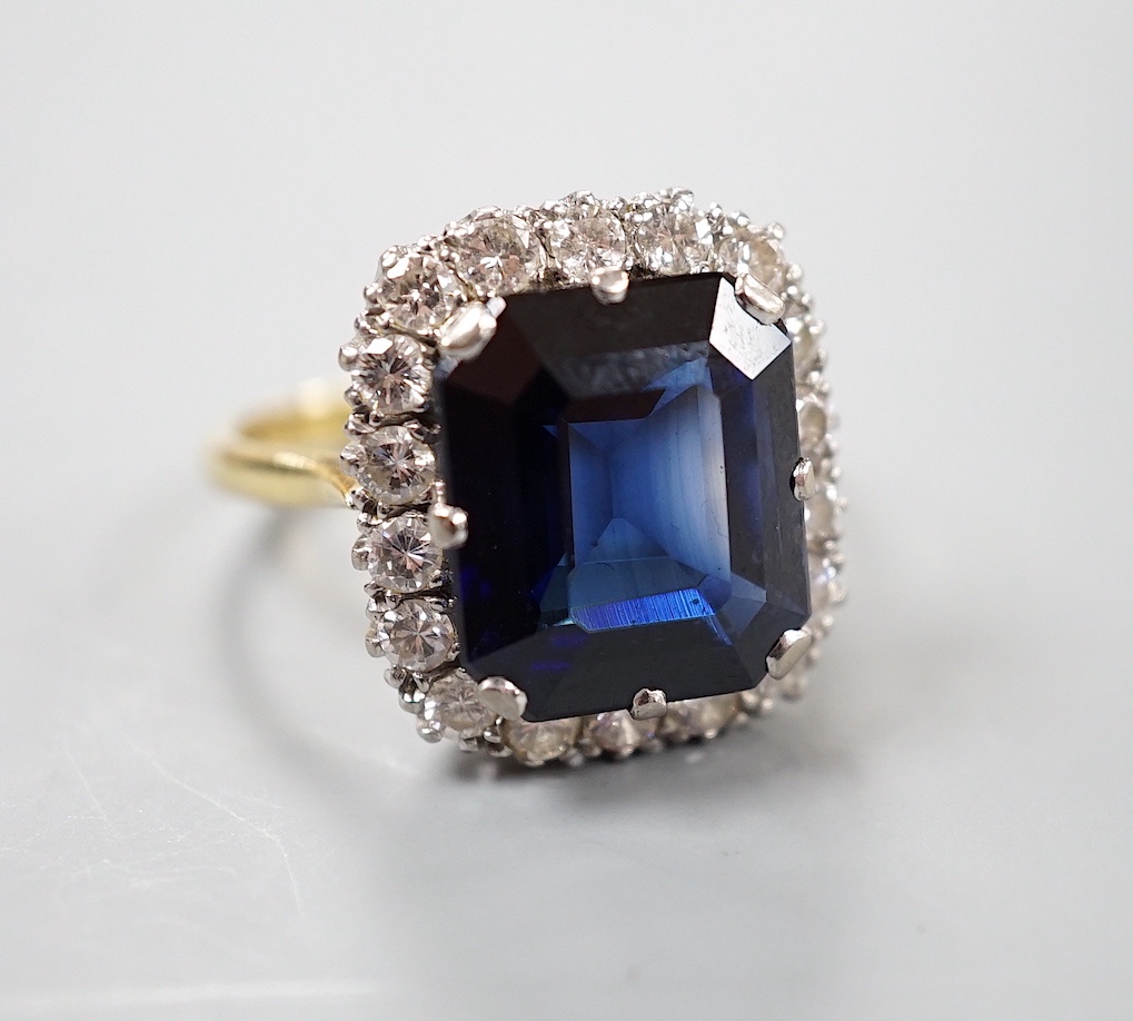 An 18ct, synthetic sapphire and diamond set rectangular cluster dress ring, size T/U, gross weight 10 grams.